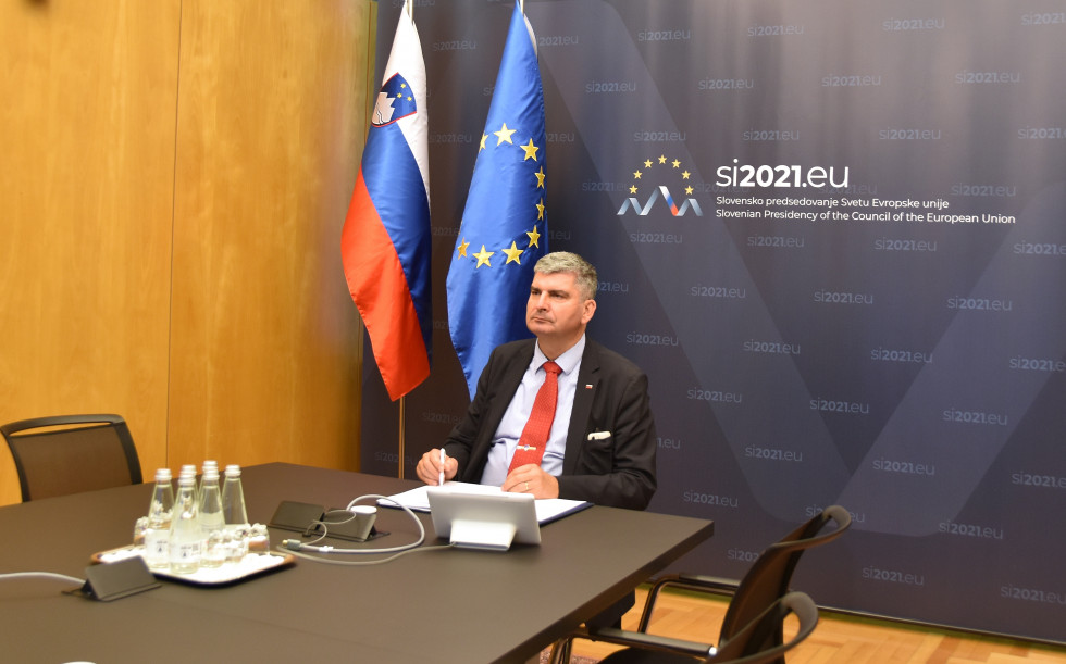 state secretary Raščan during the video conference, sitting at the table