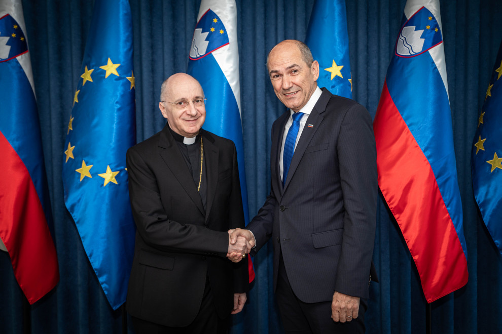 Prime Minister Janez Janša shakes hands with the Doyen of the Diplomatic Corps in Slovenia, the Apostolic Nuncio to Slovenia, Archbishop Jean-Marie Speich.