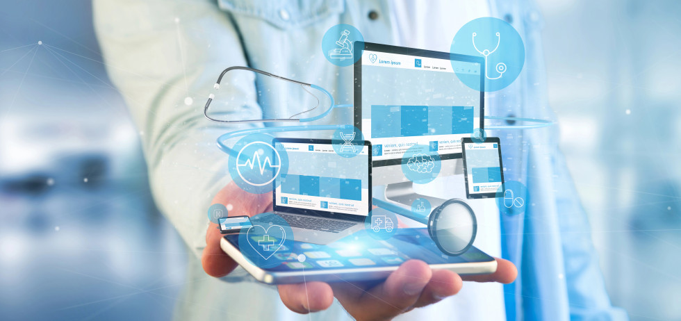 oseba v beli halji drži pametni telefon