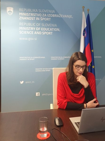 Ministrica preko računalnika sodeluje na virtualni konferenci