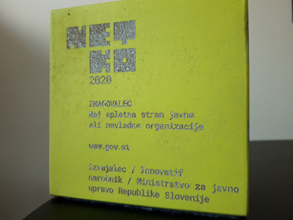 nagrada v obliki betonske kocke z natisnjenim napisom o prejemniku nagrade