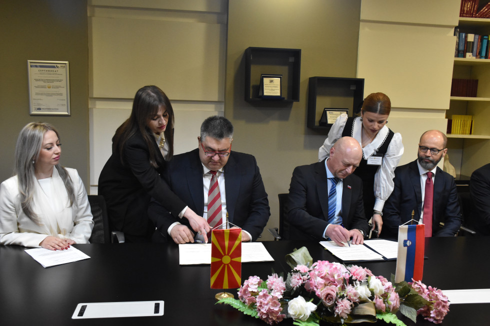 Slovenia's minister and North Macedonia's minister signing the memorandum