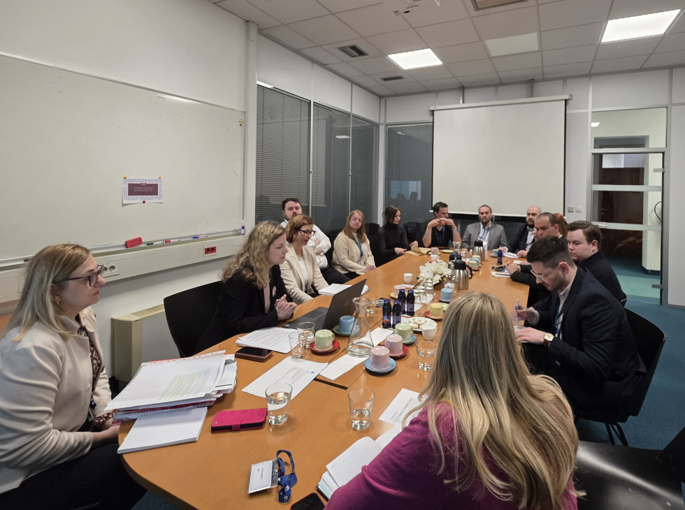 Meeting participants are sitting at a table