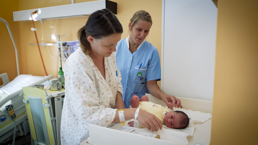 Midwife with baby and mother