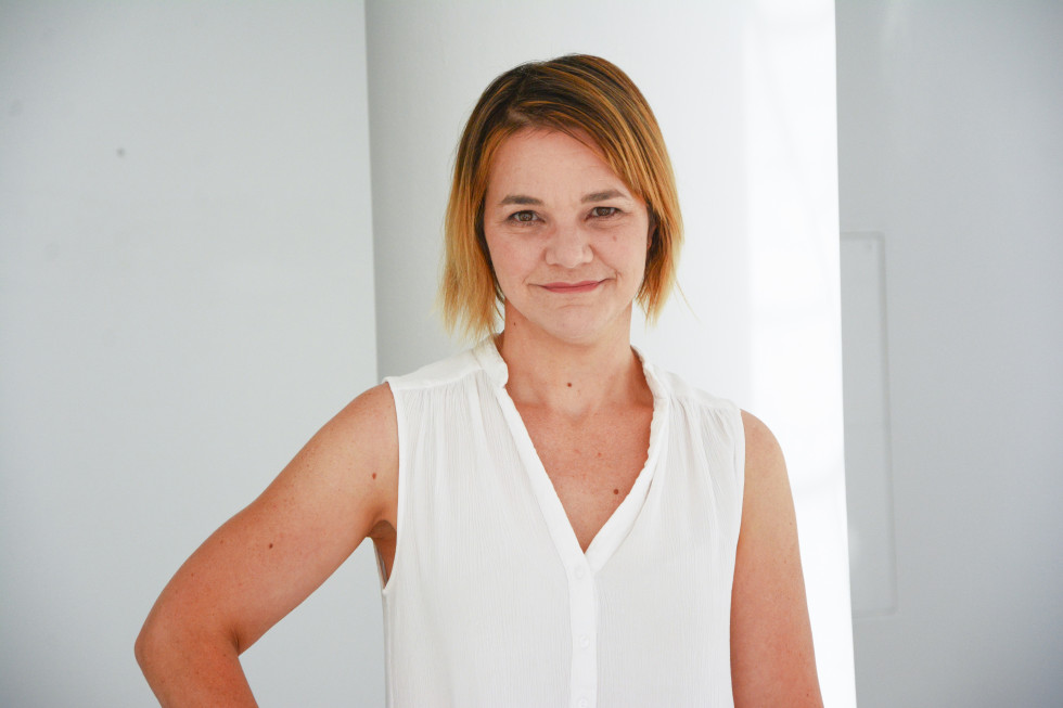 Portrait of a woman in a white tank top on a white background