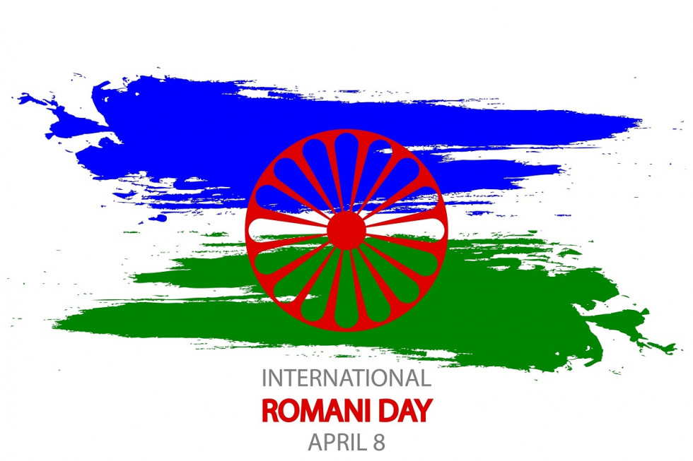 Modra in zelena poteza s čopičem, ki predstavljata romsko zastavo, z rdečim kolesom v sredini in napisom International Romani Day. April 8