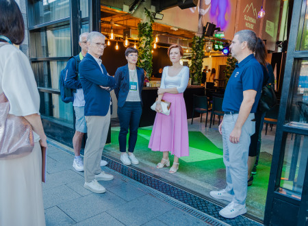 Representatives of Slovenia during a chat in front of the entrance to the House of Slovenia, including the Minister of Culture and the President of the Olympic Committee of Slovenia.