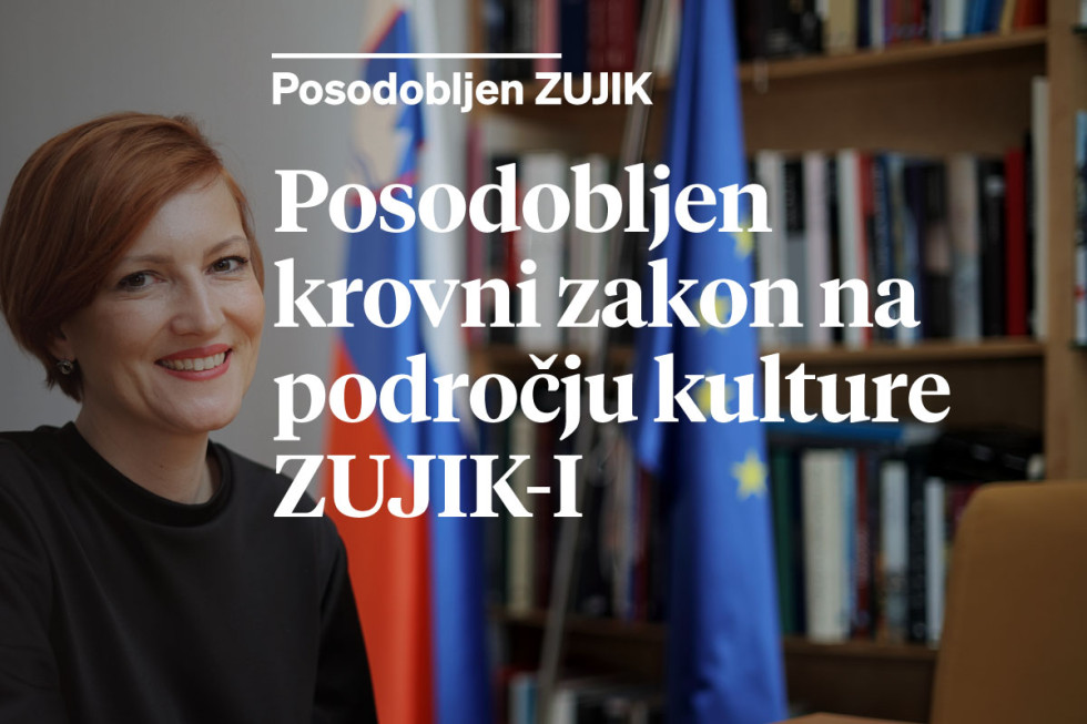 Nasmejana ministrica za kulturo z napisom Posodobljen krovni zakon na podorčju kulture ZUJIK-I
