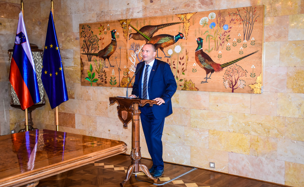 Minister in a blue suit during a speach