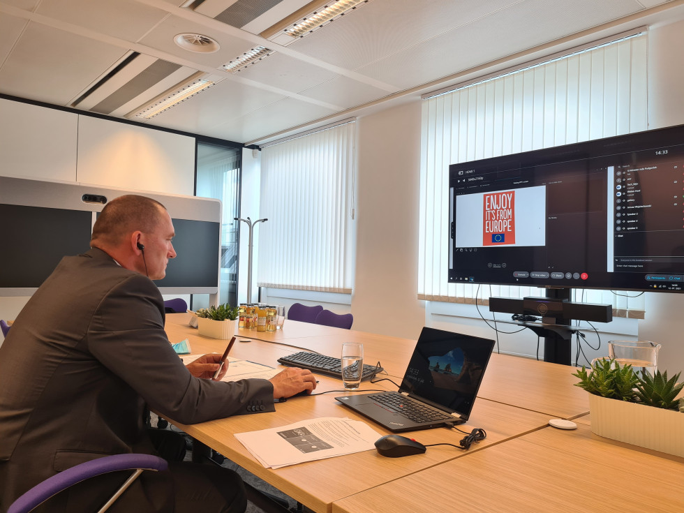 Minister Jože Podgoršek sitting in front of a computer 