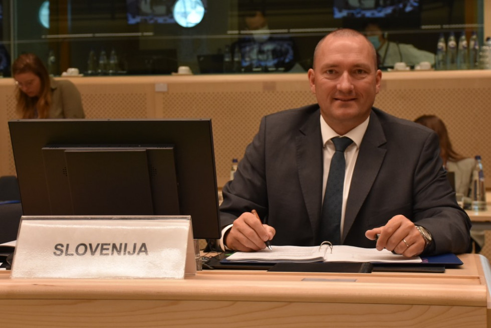 Minister sitting at his desk and listening. 