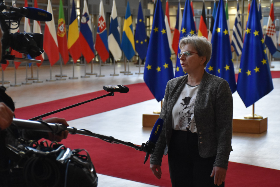 Minister standing in front of the microphones and talking. 