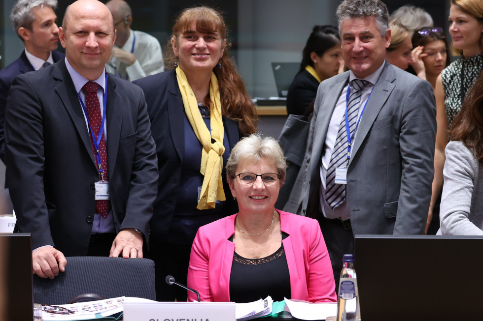 Minister sitting at her table and taking pictures with her team. 