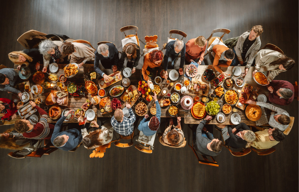 People are sitting at the table and eating. 