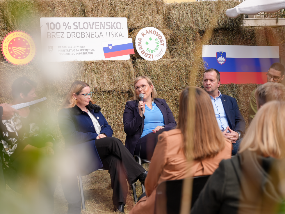 Osebe sedijo in se pogovarjajo. 