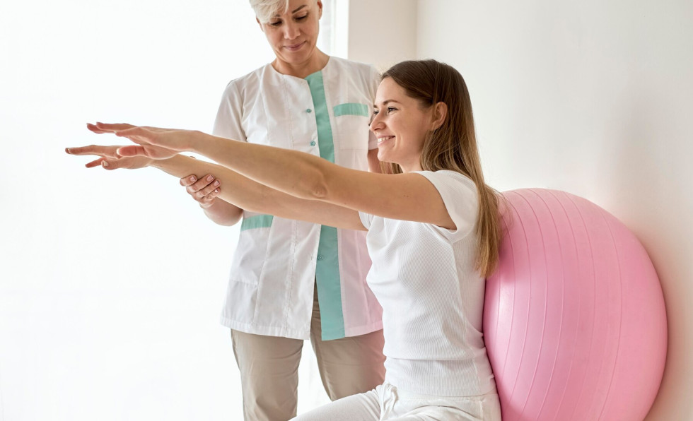 Symbolic photo. Performing physiotherapy exercises with a ball supported against a wall.
