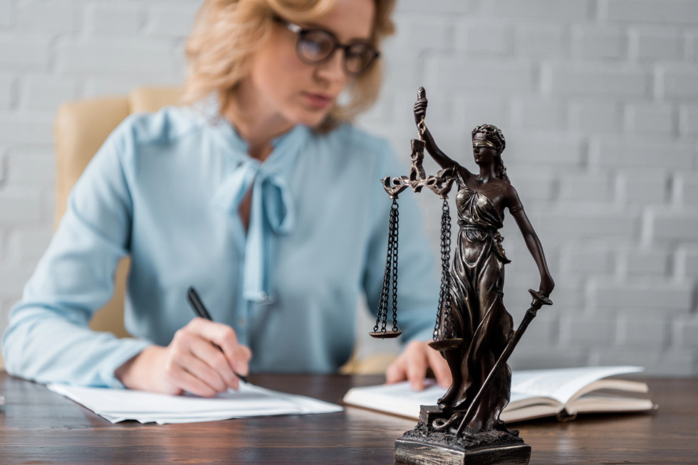 A person sitting at a desk and writing.