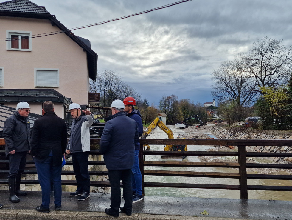 minister, predstavniki direkcije in župan si ogledujejo potek del v reki