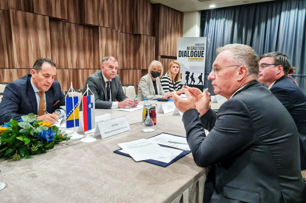 The participants in the bilateral session sit at a table during the discussion