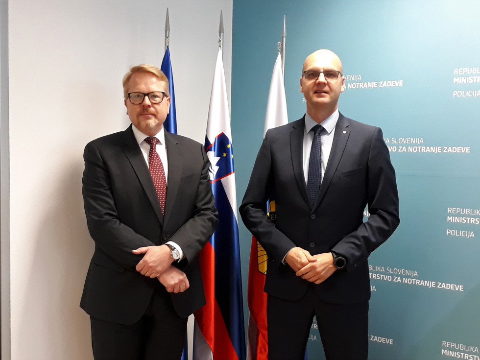 The Assistant Director General of the Police, Jože Senica, and the EU Counter-Terrorism Coordinator, Ilkka Salmi, bothe standing in front of the flags