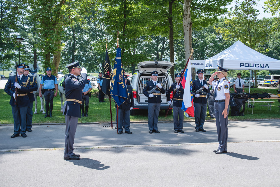Generalna direktorica policije mag. Tatjana Bobnar pozdravlja policiste, v ozadju praporščaki s prapori