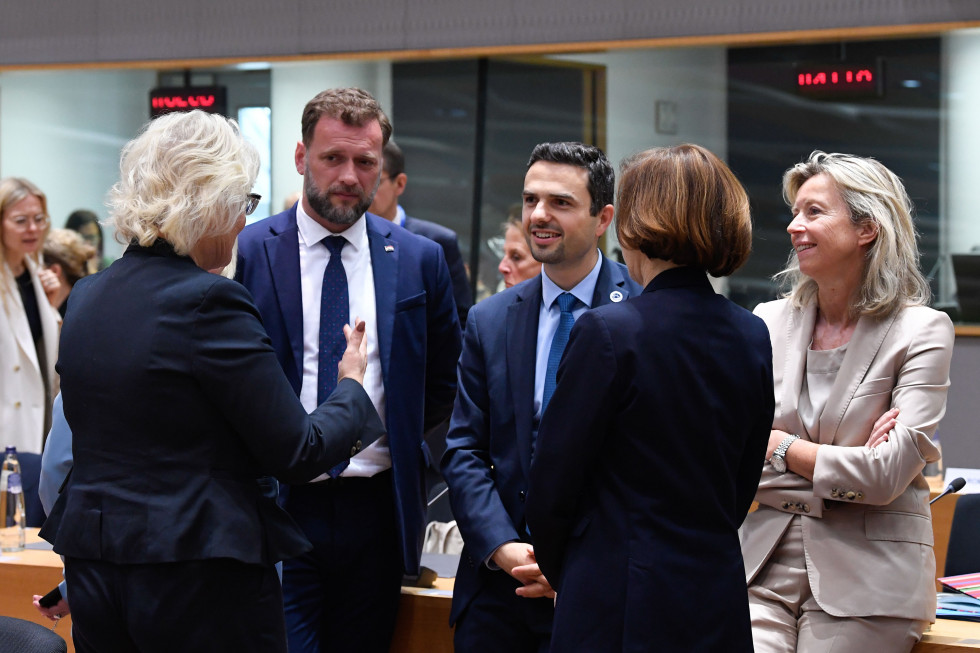 A group of ministers talking before the meeting