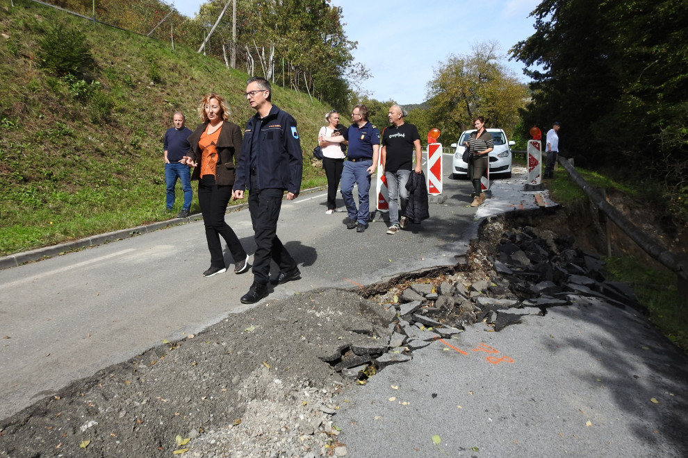 Minister Šarec and Mayor Kovač stand next to a road encroachment