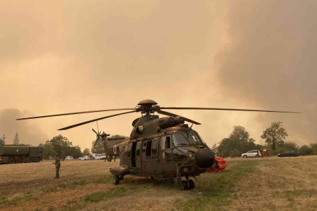 Slovenian Armed Forces helicopter extinguishing a fire.