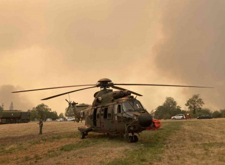 Slovenian Armed Forces helicopter extinguishing a fire.