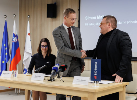 Jamnik in Maljevac se rokujeta, zadaj sedi Šarc Majdič