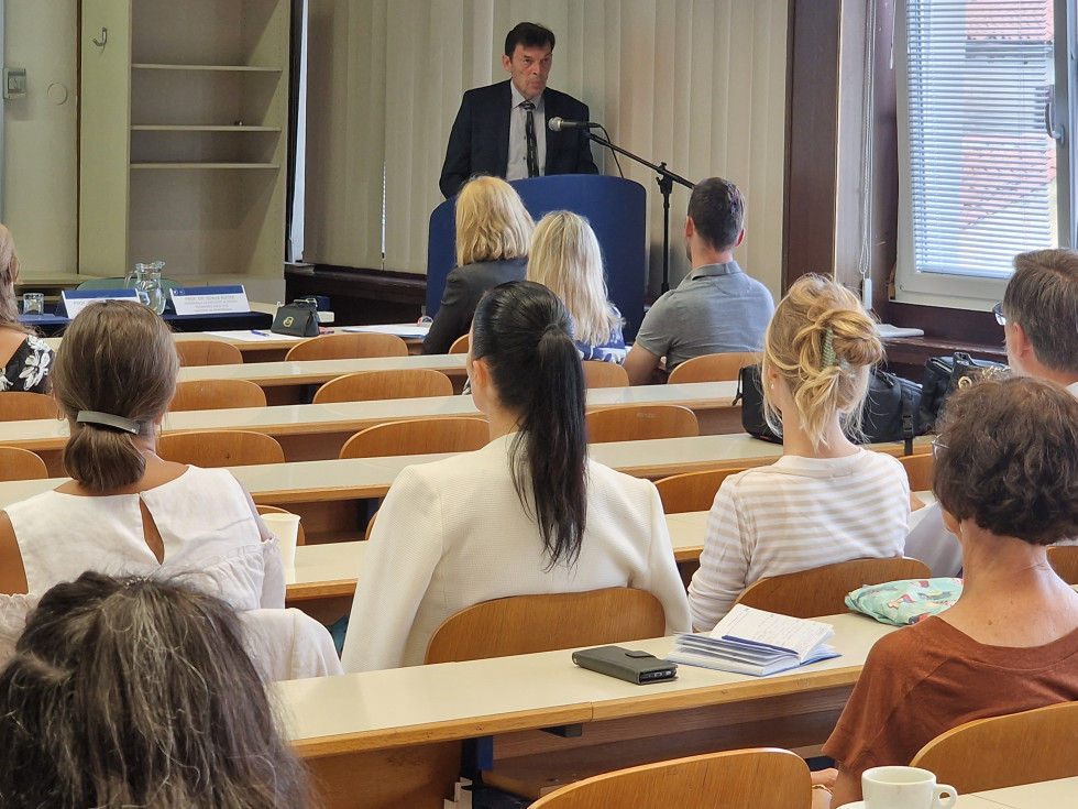 Minister Logaj nagovarja zbrane udeležence razprave.