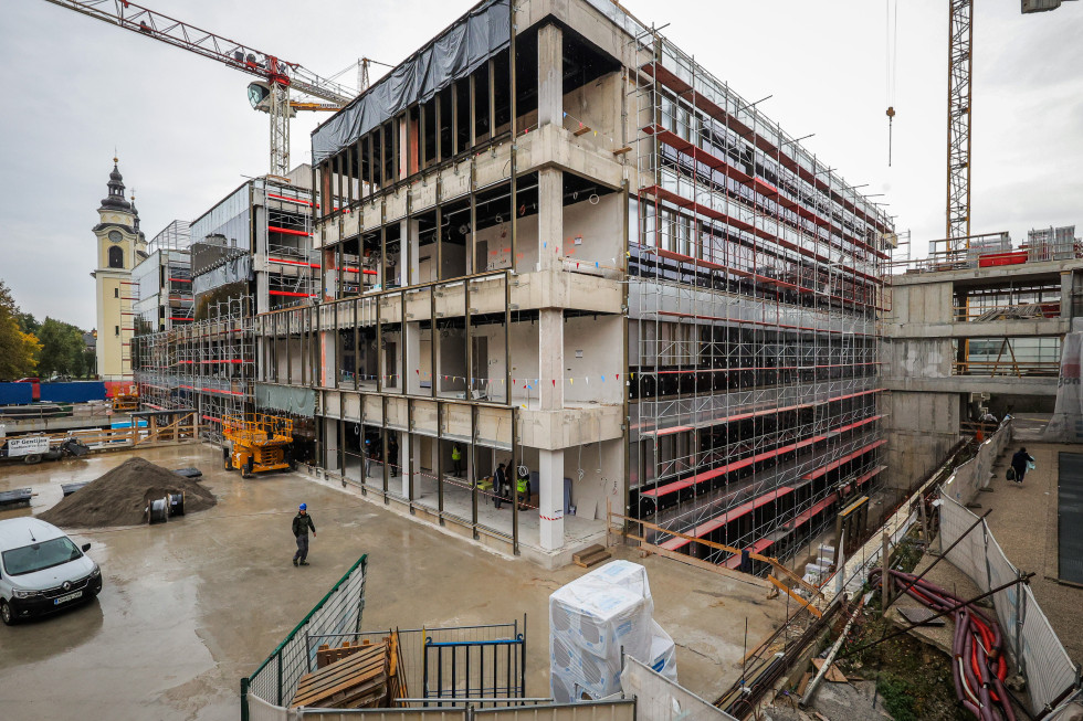 A building in the final phase of construction, with some exterior elements yet to be completed.