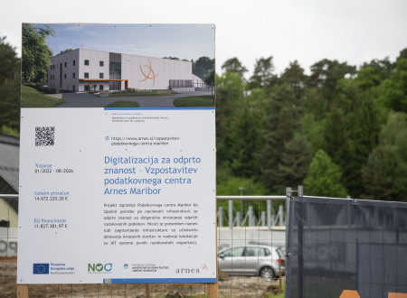 Gradbišče novega podatkovnega centra v Mariboru. V ospredju tabla z osnovnimi informacijami in vizualizacijo objekta.