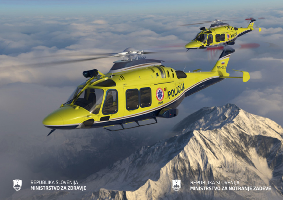 Dva rumena reševalna helikopterja letita nad goratim zasneženim območjem.