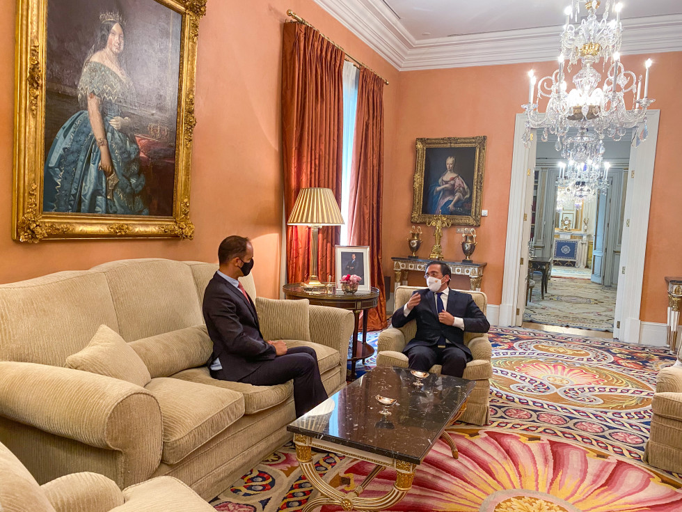 sitting in armchairs, colorful carpets and chandelier