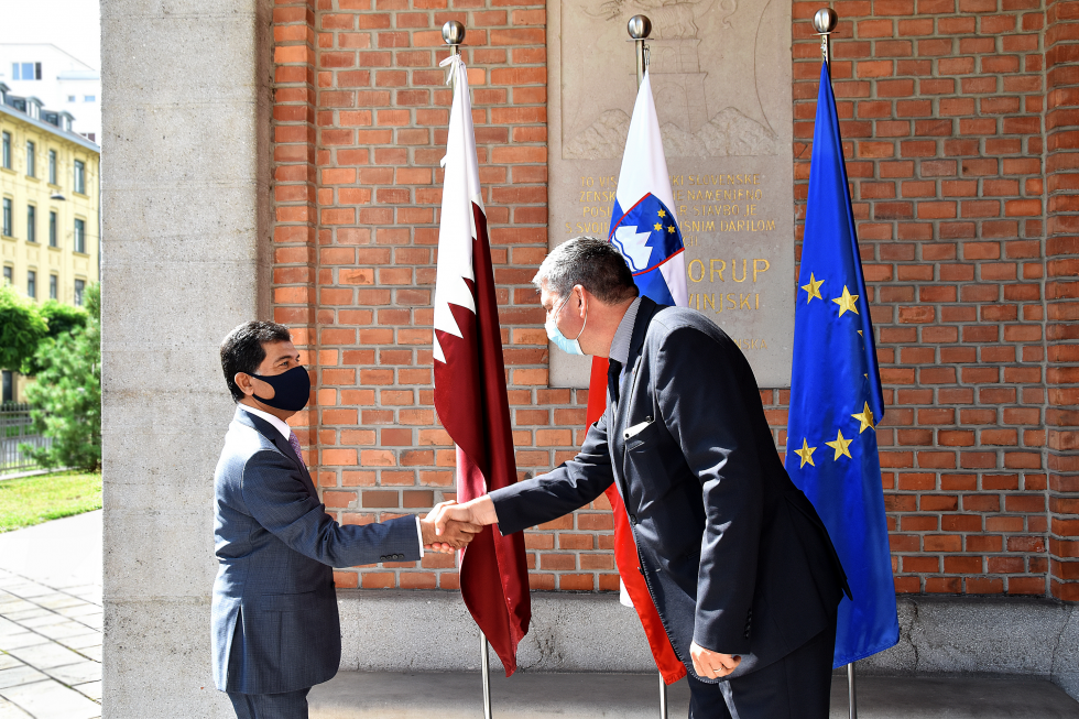 handshake in front of flags