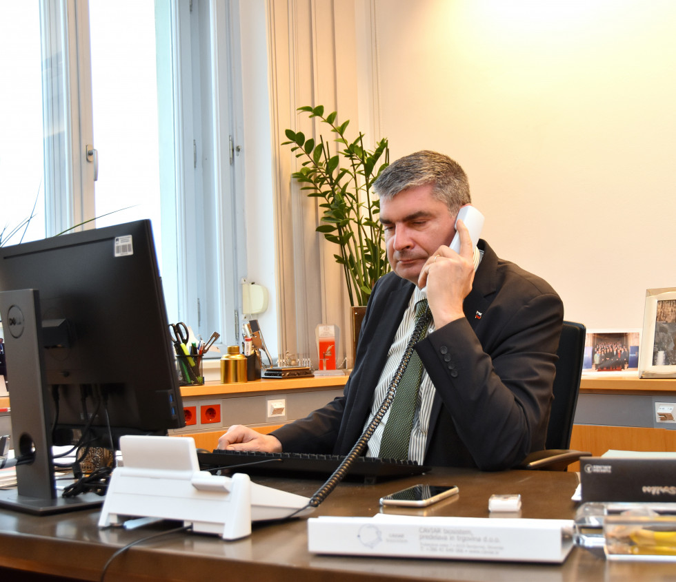 State secretary dr. Raščan is talking on the phone