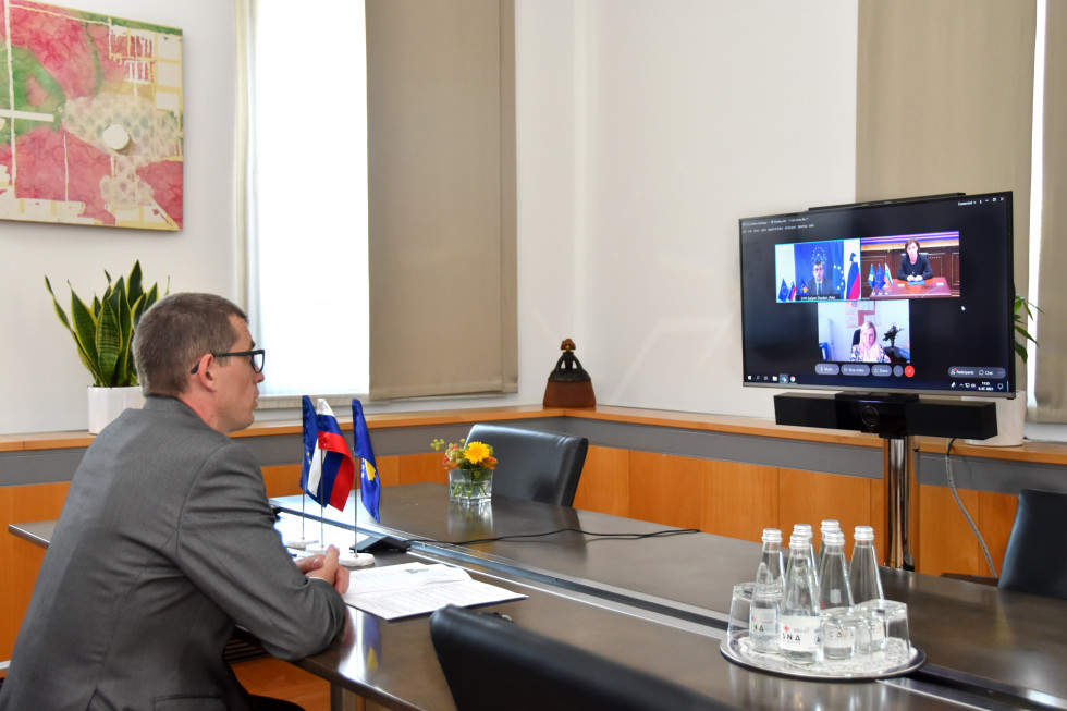 sitting, looking at computer screen with participants