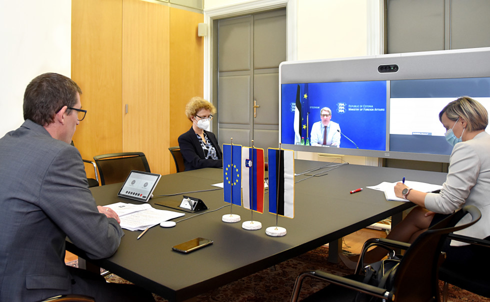 at the table, looking at computer screen, flags on table 