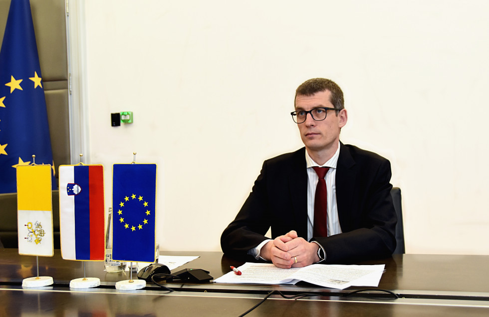 sitting at his desk with small flags