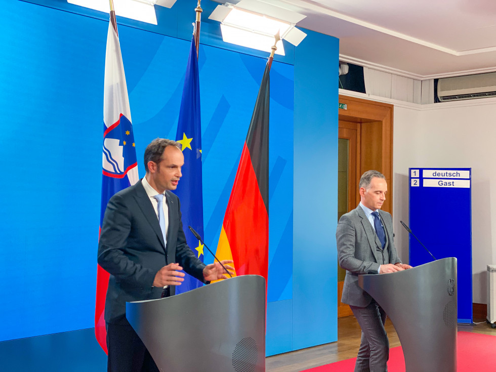 press conference, standing with flags behind