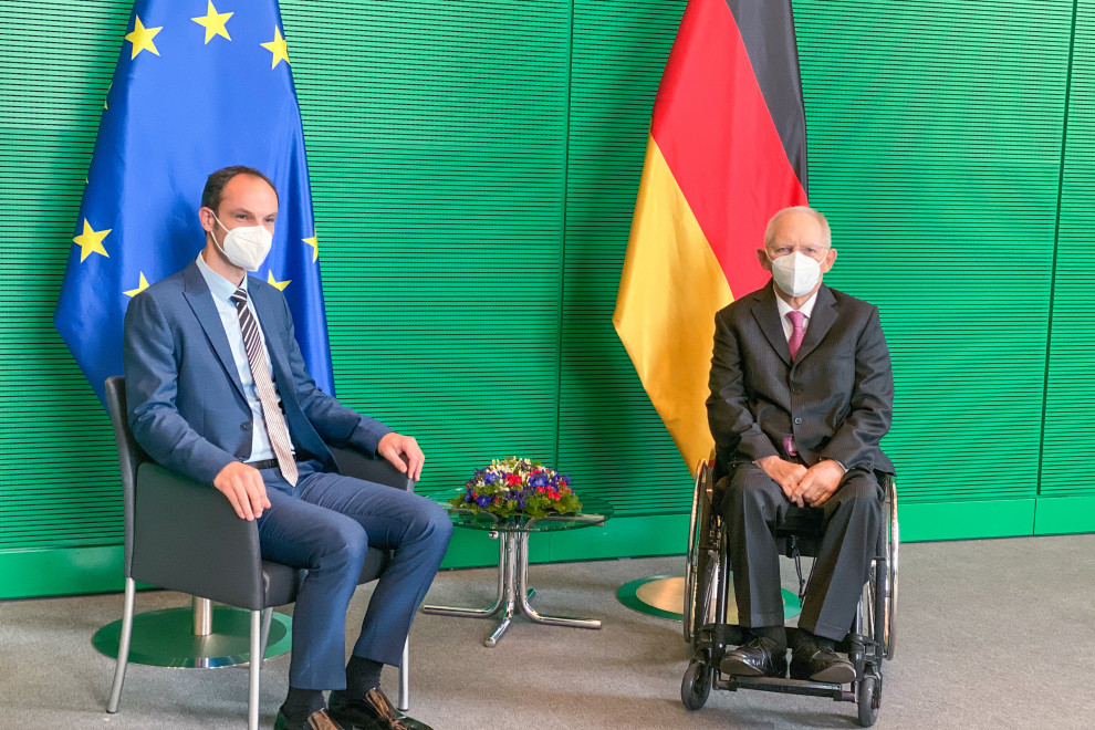 sitting with flags behind