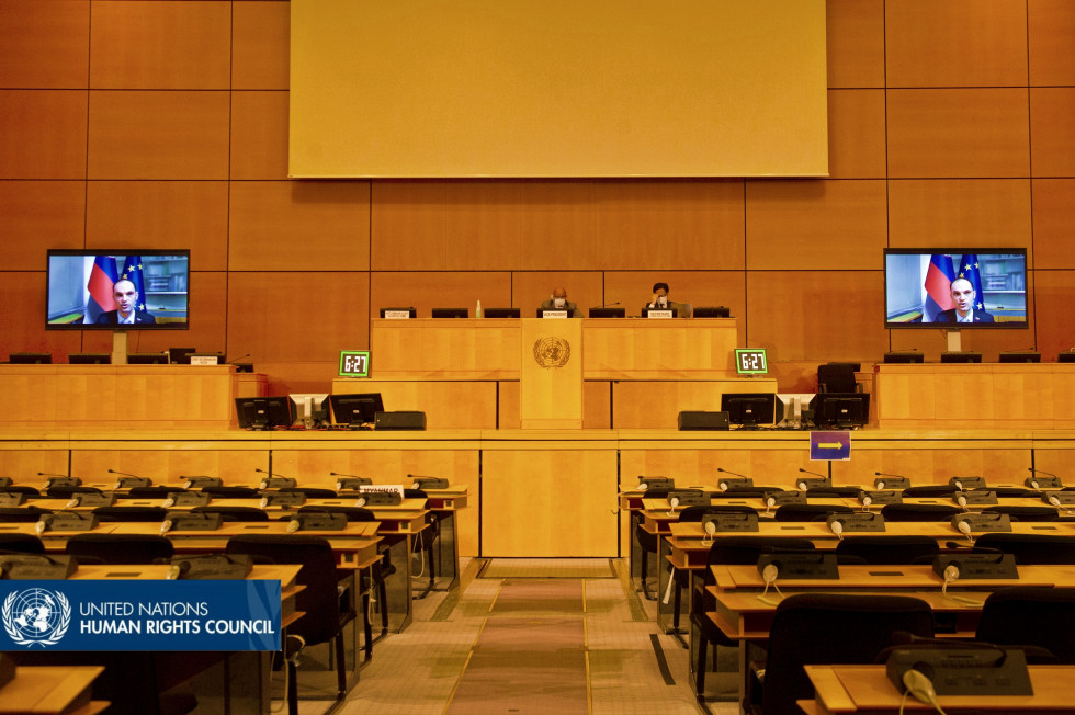 conference room with screens and some participants