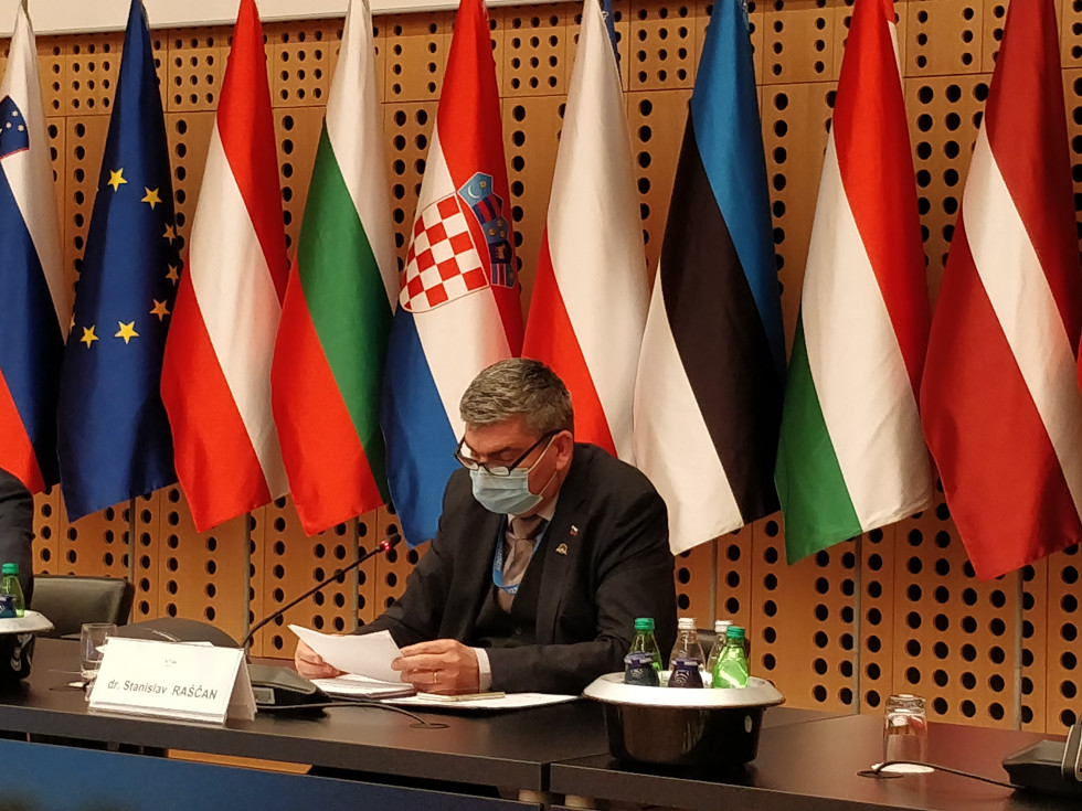 State Secretary Raščan sitting, giving a speech