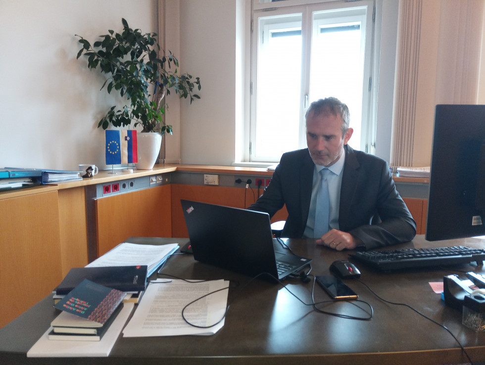 Igor Jukič sitting at the table during the video conference