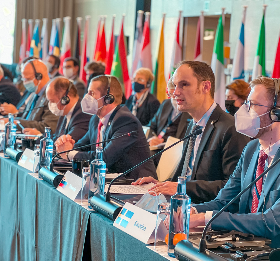 minister Anže Logar sitting at the table, talking