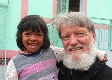Pedro Opeka holding a little girl