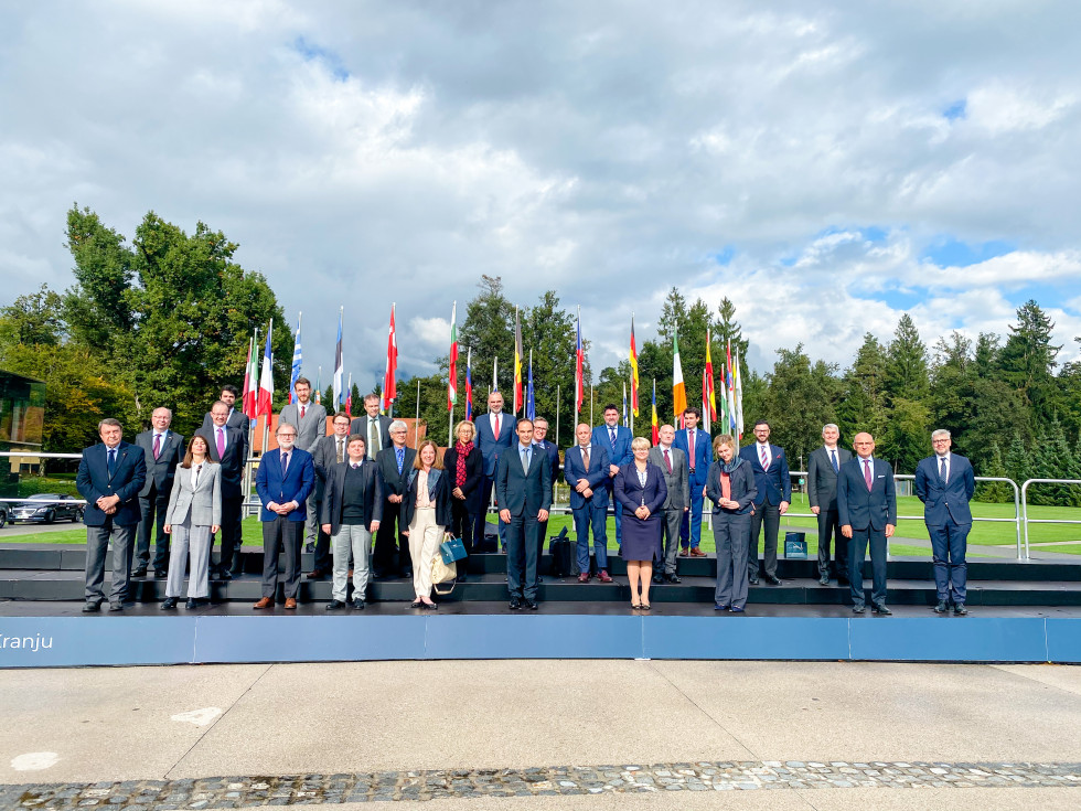 group photo in front of flags