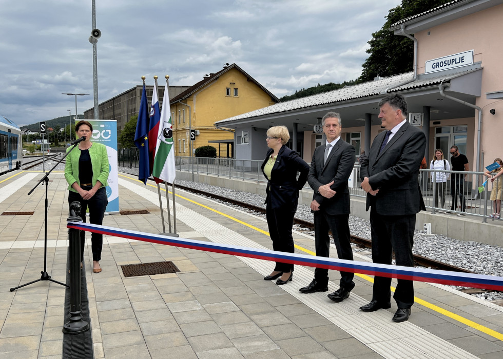 Four people stand in front of the ceremonial ribbon