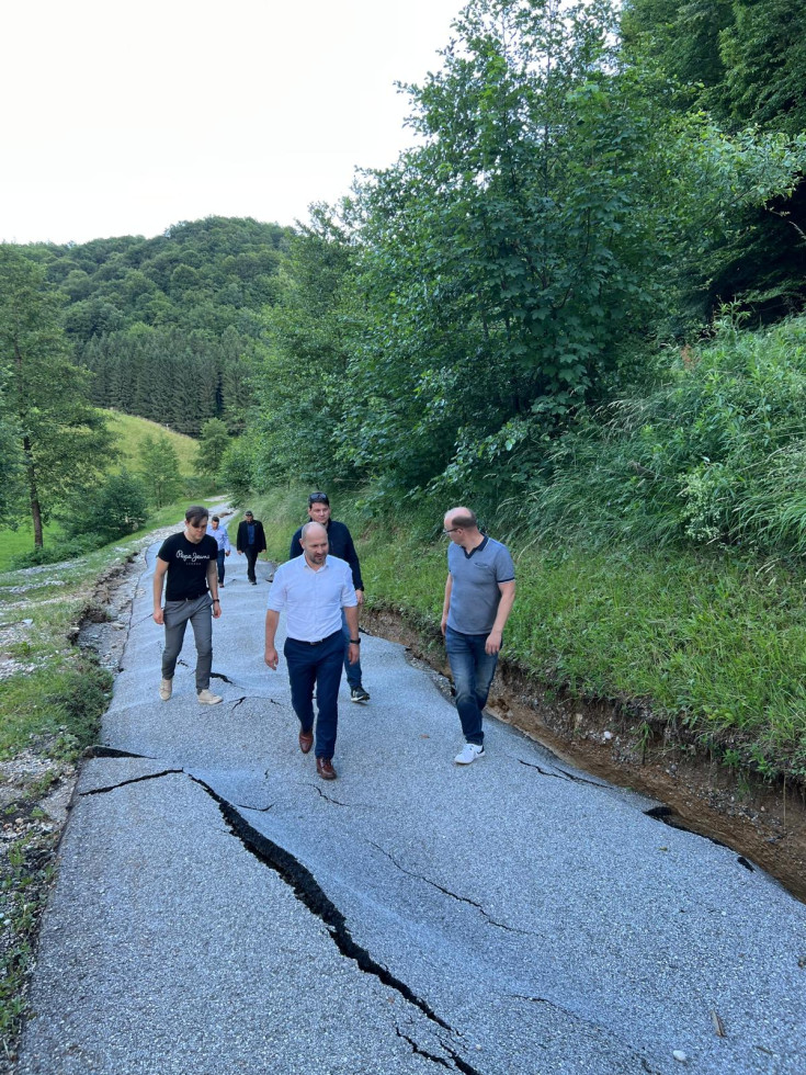 Minister inspecting a damaged road
